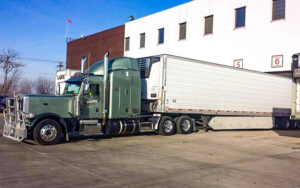 Hensley semi truck docked at a warehouse